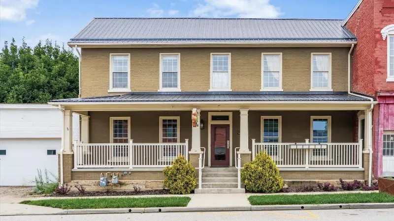 Two-story brick building with a covered front porch at 120 W Main Street, Somerset, Ohio